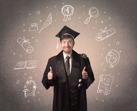 Happy graduate teenager with hand drawn school icons above his head
