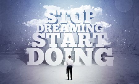 A lazy sales person standing in emty space with huge block letters illustration saying stop dreaming start doing and clouds concept