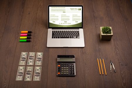 Business wooden table with notebook computer and office accessories