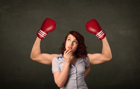 Pretty young woman with strong and muscled boxer arms concept