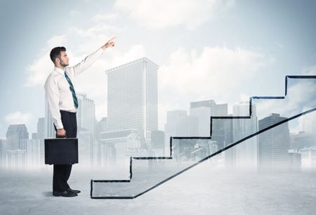 Business person in front of a staircase, city on the background
