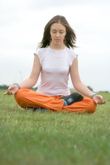 beautiful girl doing yoga in the park