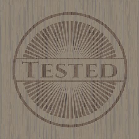 Tested badge with wooden background