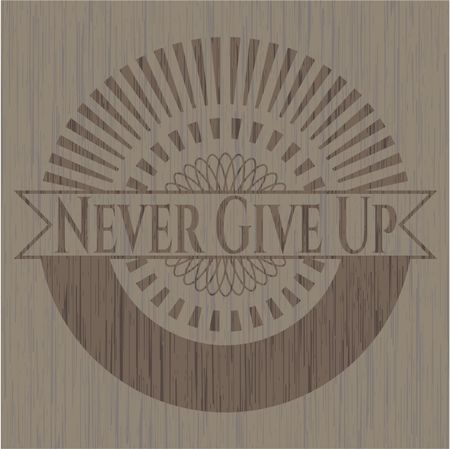 Never Give Up badge with wooden background