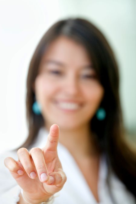 business woman pointing at the screen smiling and isolated over white