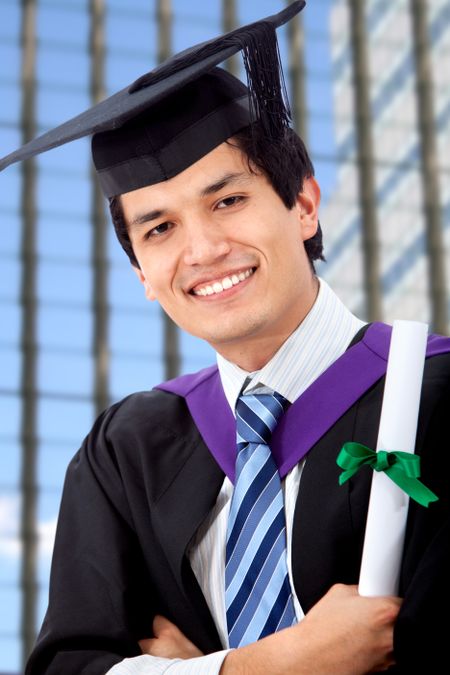 male graduation portrait smiling and showing his diploma