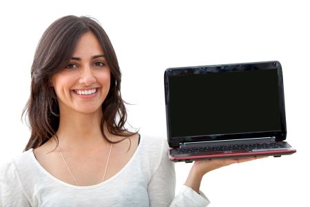 Beautiful happy girl with a computer isolated on white