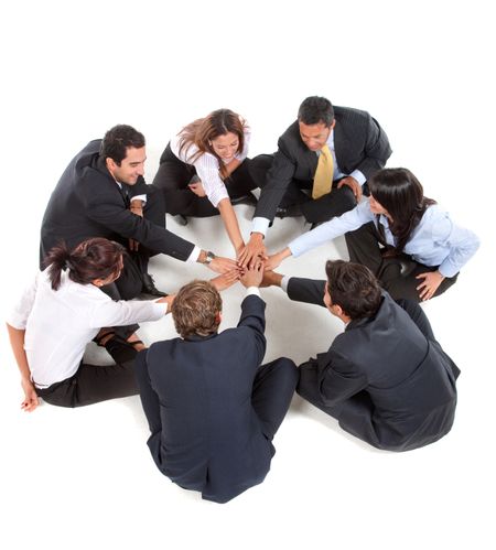 Businessgroup with hands together isolated on white