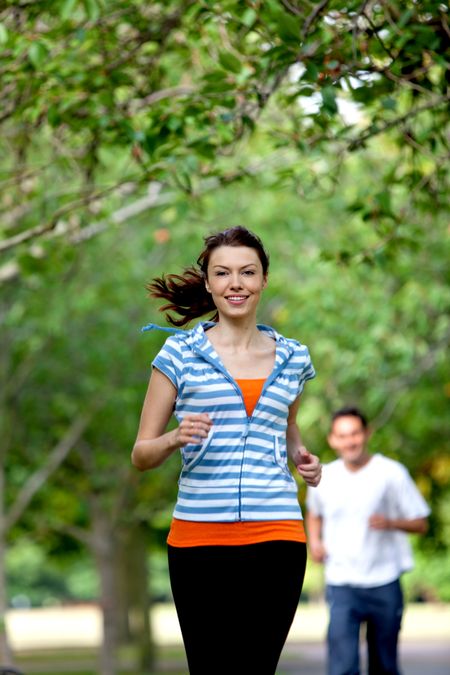 Beautiful casual girl running at the park