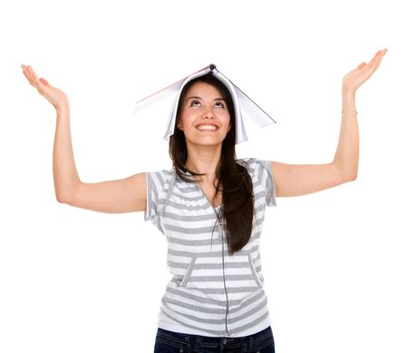 Happy student with a notebook on top of her head isolated on white