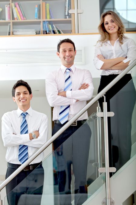 business team standing and smiling in an office