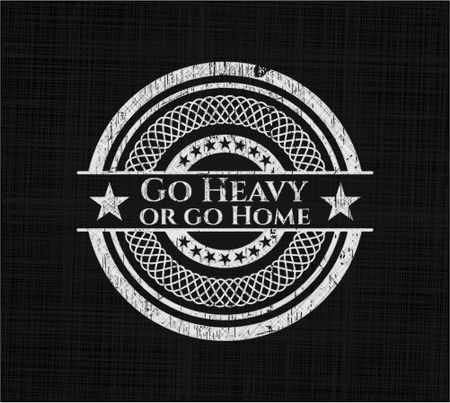 Go Heavy or go Home chalkboard emblem written on a blackboard