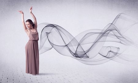 Modern ballet dancer performing with abstract swirl concept on background