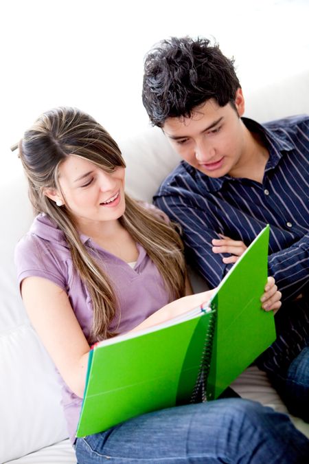 couple of students smiling and studying at home