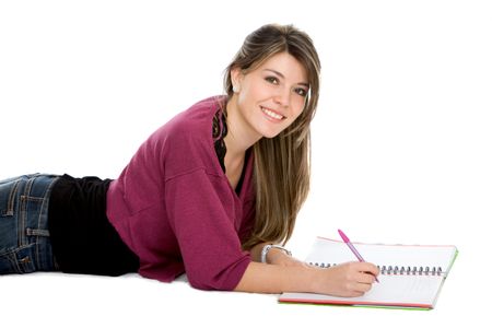 Beautiful female student lying on the floor with a notebook - isolated over white