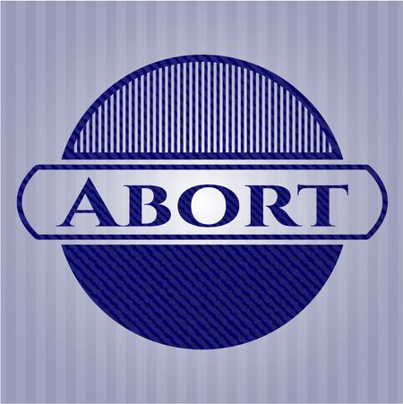 Abort badge with denim background
