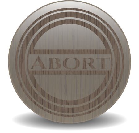 Abort badge with wooden background