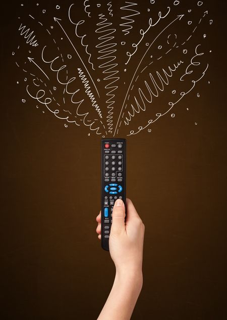 Hand holding a remote control, curly lines and arrows coming out of it
