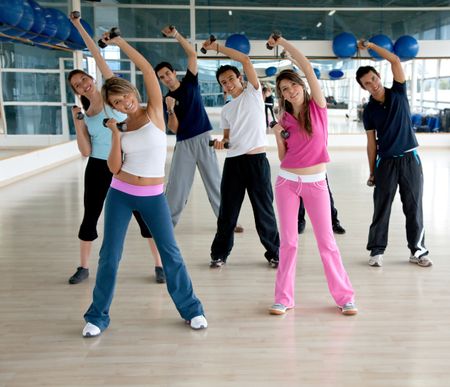 Group of people exercising at the gym with freeweights