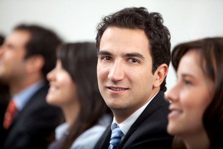 Business man smiling with a group at the office