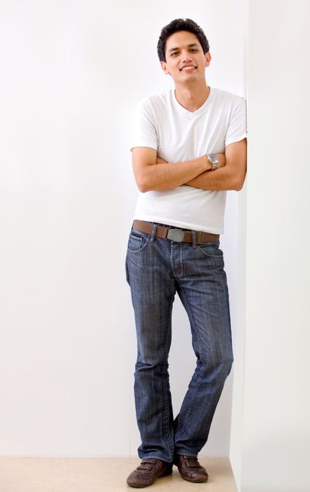 Casual man leaning on the wall and smiling