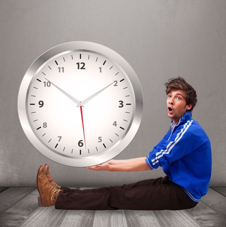 Attractive young boy holding a huge clock