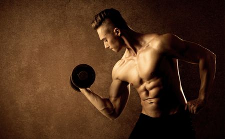 Muscular fit bodybuilder athlete lifting weight on grungy background
