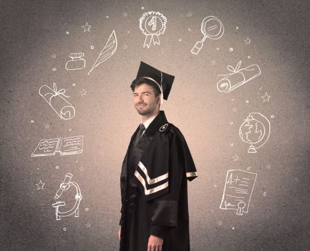 Happy graduate teenager with hand drawn school icons above his head
