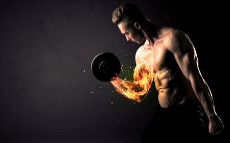 Bodybuilder athlete lifting weight with fire explode arm concept on background