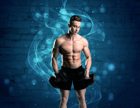 A sexy body builder lifting weight and showing his muscular, hot body in front of a blue urban brick wall with drawn light beams concept