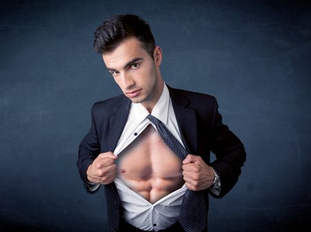 Businessman tearing off his shirt and showing mucular body concept on background