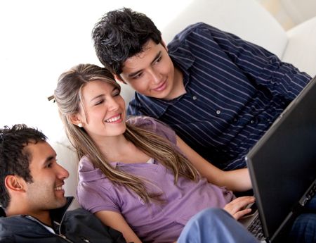 Casual group of young students with a laptop