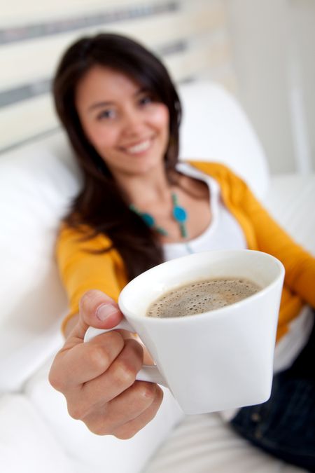 Woman sitting on the sofa drinking coffee