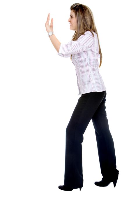 Business woman pushing something isolated over a white background