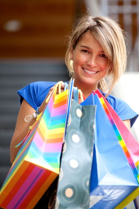 Beautiful shopping woman at a mall smiling