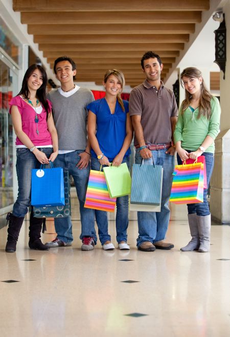 Group of shopping people with bags smiling