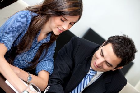 Successful business couple at the office smiling