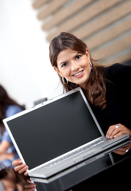 Beautiful business woman with a laptop and smiling