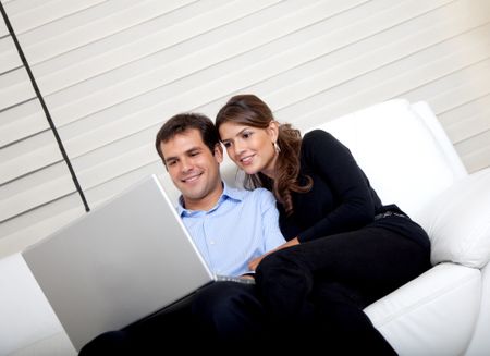 Business couple working from home with a laptop