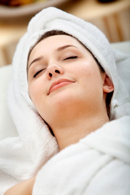 Woman enjoying her facial treatment at the spa