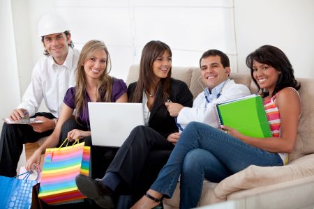 Group of happy people with different professions sitting on a sofa