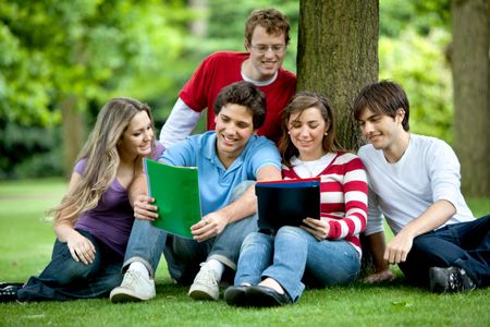 Happy group of students outdoors with notebooks