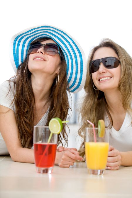 Summer girls enjoying a cocktail isolated over a white background