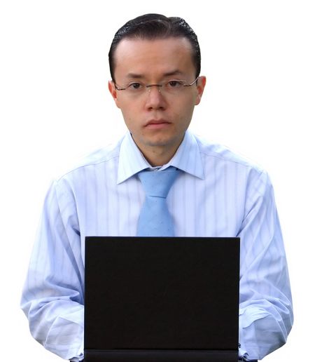 business man working on laptop with a confident look