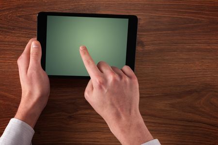 Caucasian business hands holding and working on plain tablet