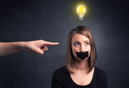 Caucasian hand pointing at female employee with a lightbulb above her head