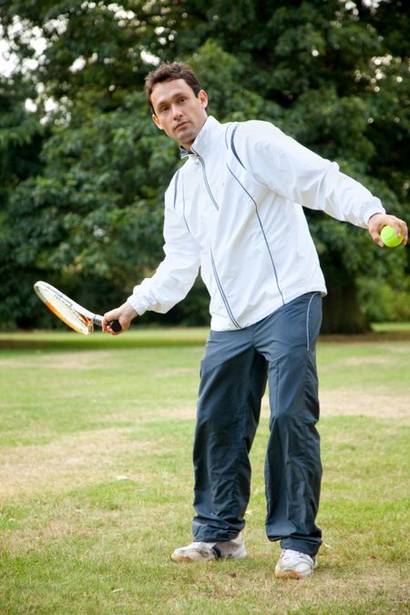 Young man practicing tennis at the park