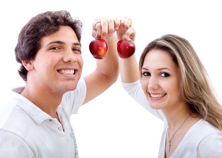 Beautiful couple holding some apples isolated on white