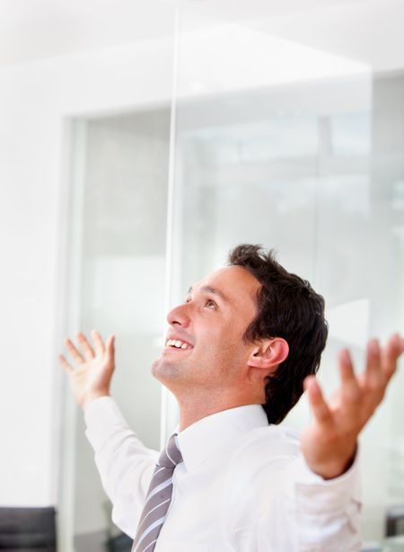 Successful business man with arms opened at the office