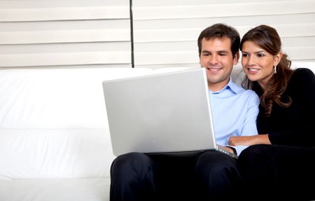 Couple at home working on a laptop